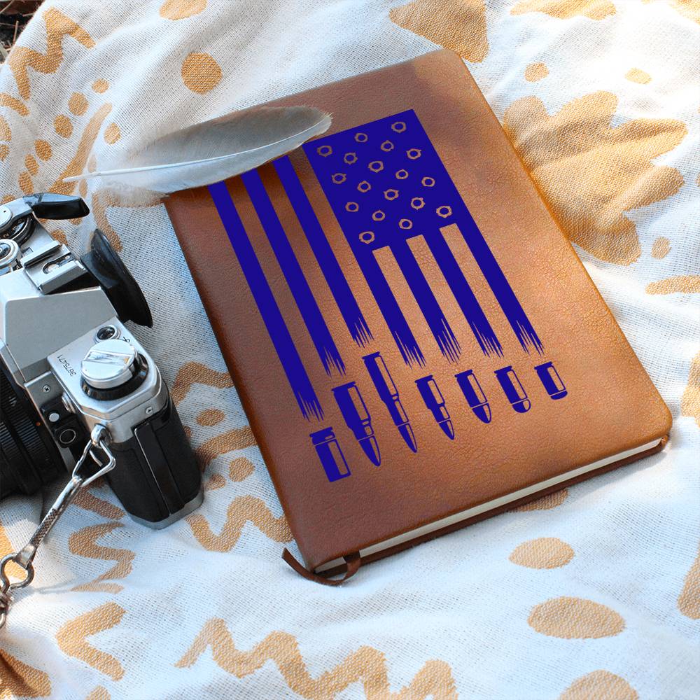 This American flag journal with bullet holes in blue on a vegan leather 100 page, lined journal may just be the best gift ever